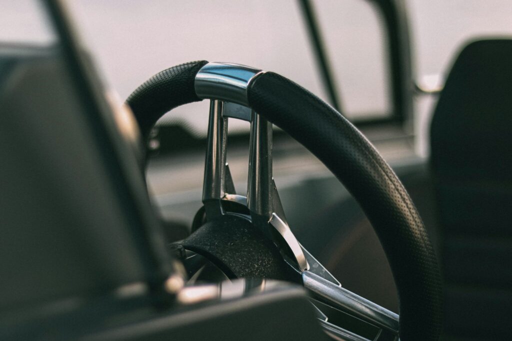Close-up of a black steering wheel inside a vehicle
