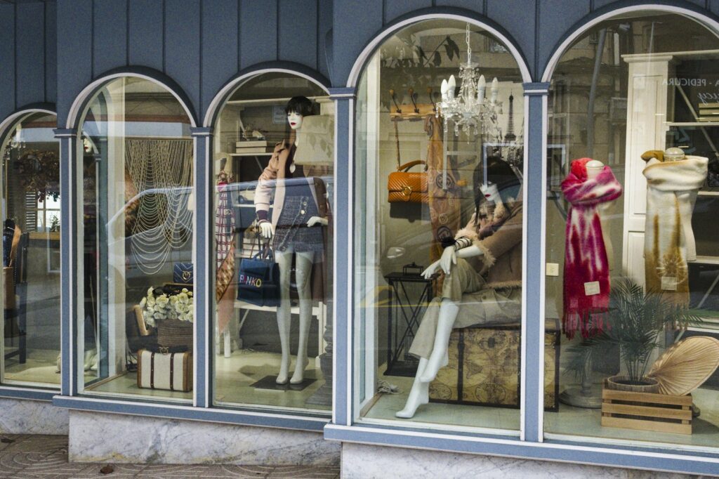 Mannequins dressed in clothing and accessories in a shop window display